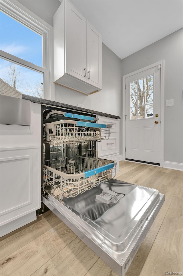5291 Devonshire Rd, Detroit, MI 48224 - kitchen view of light wood-style flooring, white cabinets, and dark countertops