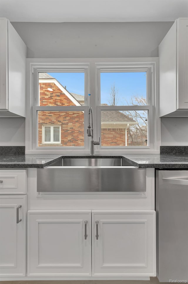 5291 Devonshire Rd, Detroit, MI 48224 - kitchen view of dishwasher, white cabinets, and dark stone countertops