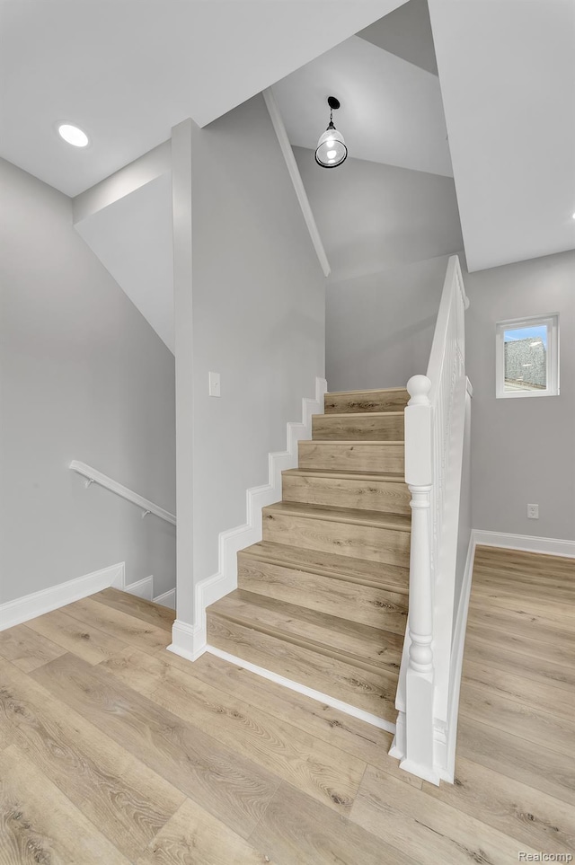 5291 Devonshire Rd, Detroit, MI 48224 - staircase with wood finished floors and vaulted ceiling