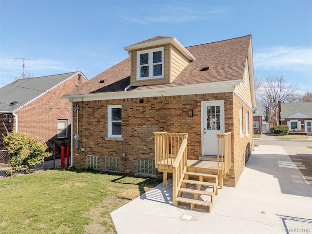 5291 Devonshire Rd, Detroit, MI 48224 - back of property featuring a yard, brick siding, and a shingled roof