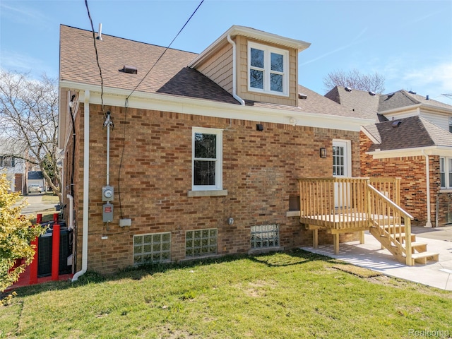 5291 Devonshire Rd, Detroit, MI 48224 - back of house with a yard, brick siding, and roof with shingles