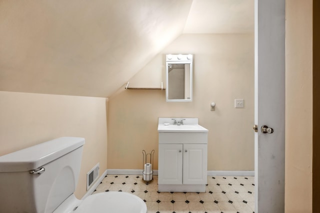 920 Wisconsin Ave, Saint Joseph, MI 49085 - half bathroom with lofted ceiling, vanity, and tile patterned floors