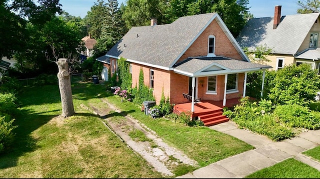 920 Wisconsin Ave, Saint Joseph, MI 49085 - view of front facade featuring a front yard, brick siding, and a porch