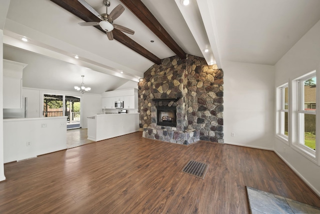 210 W Grove Ave, Michigan Center, MI 49254 - unfurnished living room featuring a ceiling fan, a fireplace, a chandelier, wood finished floors, and recessed lighting