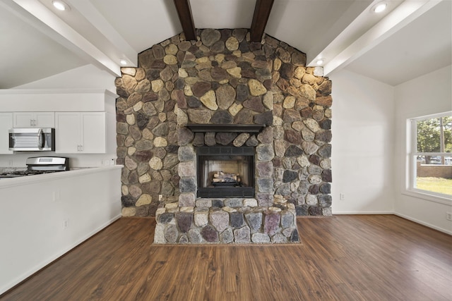 210 W Grove Ave, Michigan Center, MI 49254 - detailed view of appliances with stainless steel finishes, beam ceiling, wood finished floors, white cabinetry, and a fireplace