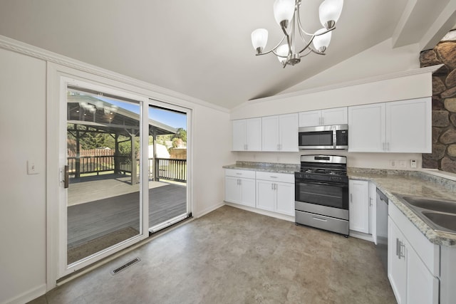 210 W Grove Ave, Michigan Center, MI 49254 - kitchen featuring appliances with stainless steel finishes, lofted ceiling, white cabinetry, and a chandelier