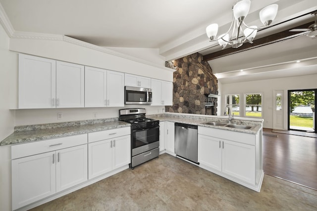 210 W Grove Ave, Michigan Center, MI 49254 - kitchen featuring appliances with stainless steel finishes, a peninsula, white cabinets, and light countertops