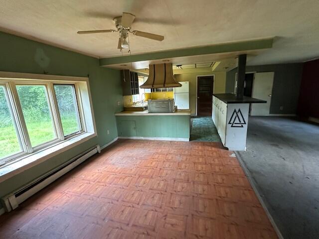 250 131st Ave, Wayland, MI 49348 - kitchen featuring a baseboard heating unit, freestanding refrigerator, a ceiling fan, custom exhaust hood, and a peninsula