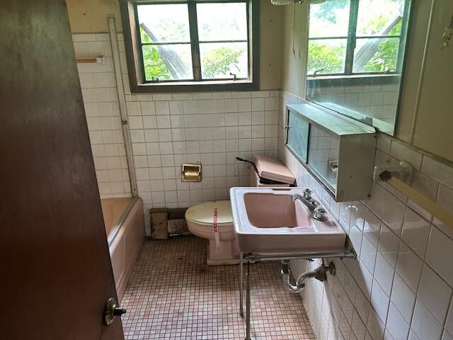 250 131st Ave, Wayland, MI 49348 - full bath featuring tile walls, tub / shower combination, and tile patterned flooring