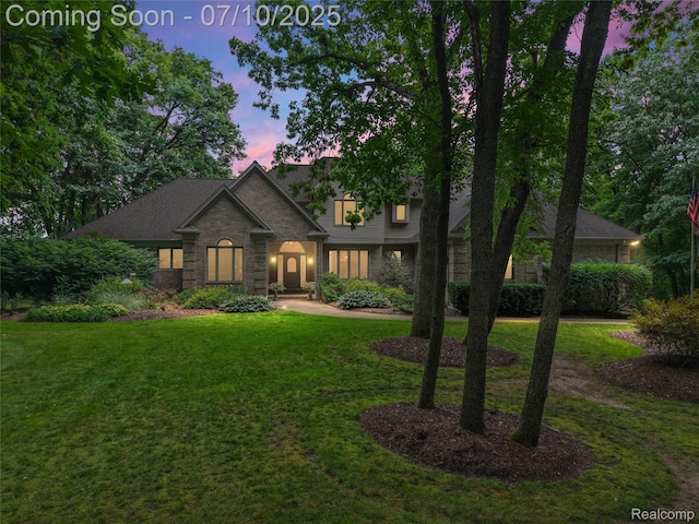 1444 W Clarkston Rd, Lake Orion, MI 48362 - traditional-style home with a lawn and brick siding
