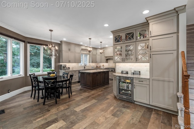 1444 W Clarkston Rd, Lake Orion, MI 48362 - kitchen with wine cooler, dark wood-style flooring, a chandelier, healthy amount of natural light, and recessed lighting
