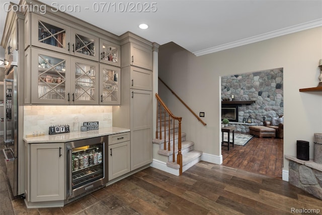 1444 W Clarkston Rd, Lake Orion, MI 48362 - indoor dry bar with wine cooler, stairs, dark wood-style flooring, crown molding, and decorative backsplash