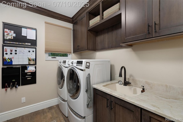 1444 W Clarkston Rd, Lake Orion, MI 48362 - washroom featuring cabinet space, washer and dryer, dark wood-style floors, and ornamental molding