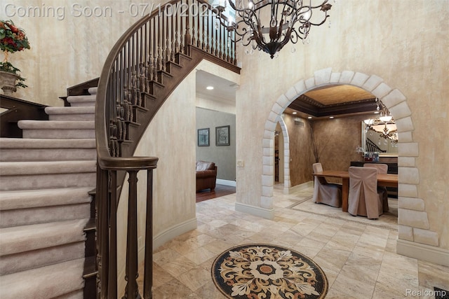 1444 W Clarkston Rd, Lake Orion, MI 48362 - stairway featuring arched walkways, a chandelier, and a high ceiling