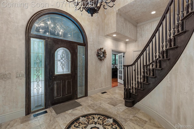 1444 W Clarkston Rd, Lake Orion, MI 48362 - foyer featuring crown molding, a chandelier, stairs, a textured wall, and a high ceiling