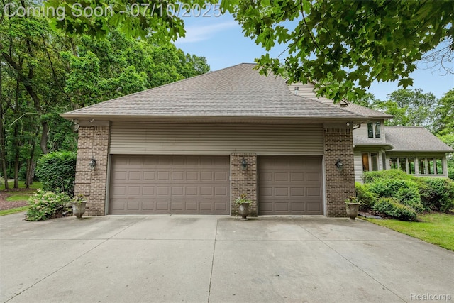 1444 W Clarkston Rd, Lake Orion, MI 48362 - view of front facade featuring brick siding, concrete driveway, a shingled roof, and an attached garage