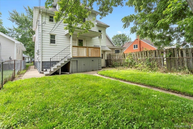 922 Maple, Wyandotte, MI 48192 - rear view of house with stairway and a fenced backyard