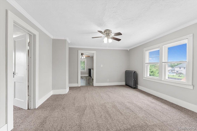 922 Maple, Wyandotte, MI 48192 - unfurnished room with radiator, a ceiling fan, light carpet, crown molding, and a textured ceiling
