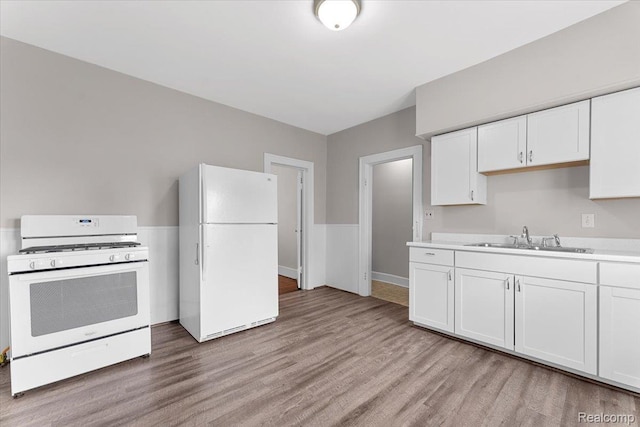 922 Maple, Wyandotte, MI 48192 - kitchen with white appliances, light wood-style floors, white cabinetry, and light countertops