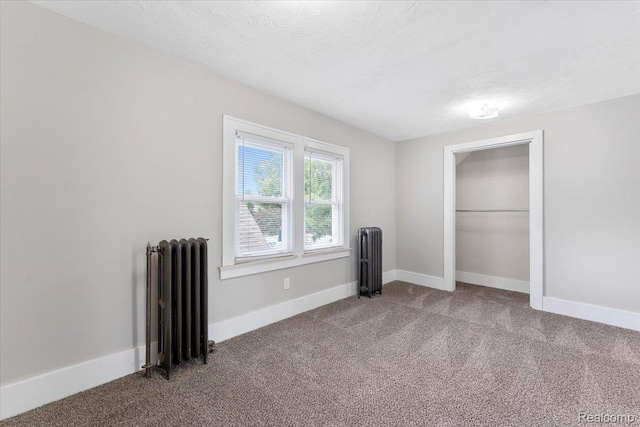 922 Maple, Wyandotte, MI 48192 - unfurnished bedroom with radiator, carpet, a textured ceiling, and a closet