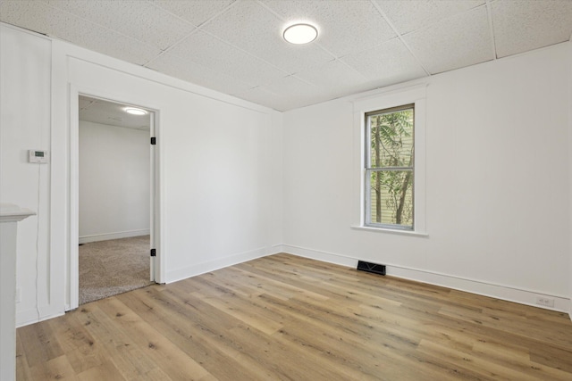 400 Burton St SW, Grand Rapids, MI 49507 - empty room with light wood finished floors and a paneled ceiling