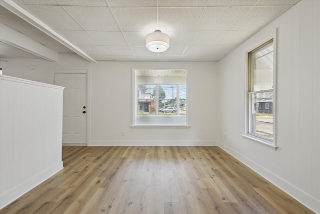 400 Burton St SW, Grand Rapids, MI 49507 - unfurnished dining area with wood finished floors, plenty of natural light, and a paneled ceiling