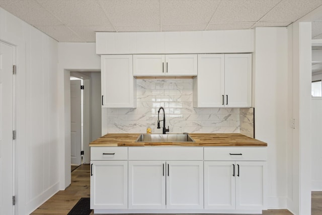 400 Burton St SW, Grand Rapids, MI 49507 - kitchen with butcher block countertops, white cabinetry, backsplash, wood finished floors, and a drop ceiling