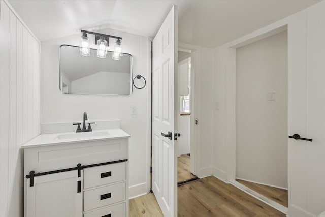 400 Burton St SW, Grand Rapids, MI 49507 - bathroom with wood finished floors, vanity, and lofted ceiling