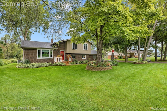 5021 Paula Ave, Clarkston, MI 48346 - tri-level home featuring brick siding, a chimney, and a front yard
