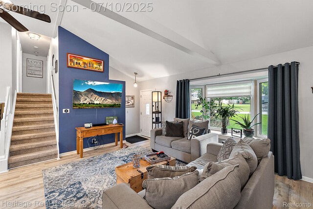 5021 Paula Ave, Clarkston, MI 48346 - living room featuring vaulted ceiling, wood finished floors, and stairway