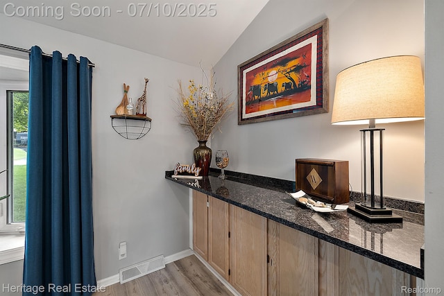 5021 Paula Ave, Clarkston, MI 48346 - bar with light wood-type flooring and lofted ceiling