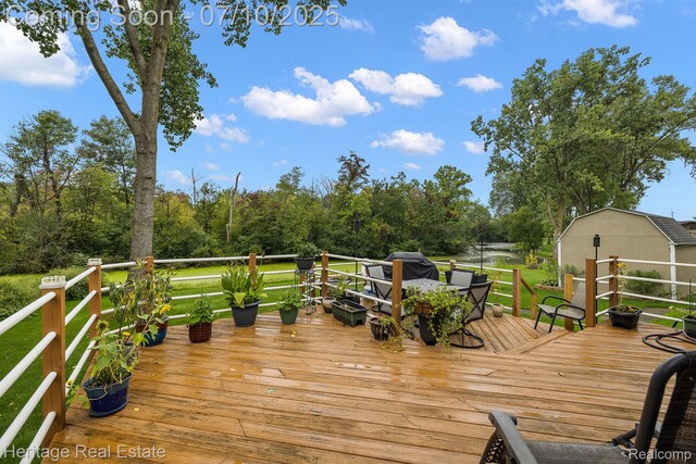 5021 Paula Ave, Clarkston, MI 48346 - wooden deck featuring outdoor dining space and an outbuilding
