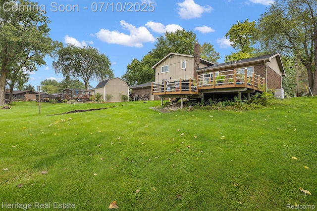 5021 Paula Ave, Clarkston, MI 48346 - rear view of property featuring a deck, a yard, and brick siding
