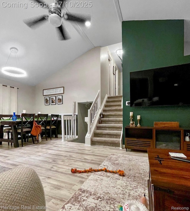 5021 Paula Ave, Clarkston, MI 48346 - living area with wood finished floors, vaulted ceiling, a ceiling fan, and stairway