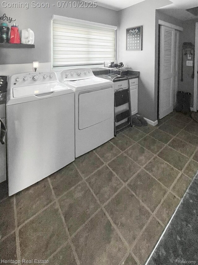 5021 Paula Ave, Clarkston, MI 48346 - washroom with washing machine and dryer and dark tile patterned floors