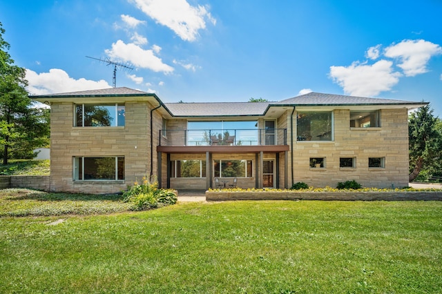 3017 Niles Buchanan Rd, Buchanan, MI 49107 - rear view of property featuring a balcony, stone siding, and a yard