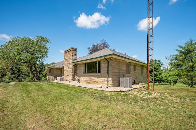 3017 Niles Buchanan Rd, Buchanan, MI 49107 - back of property featuring a chimney, a yard, and stone siding