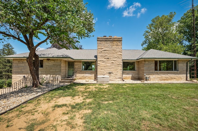 3017 Niles Buchanan Rd, Buchanan, MI 49107 - rear view of house with stone siding, a chimney, and roof with shingles