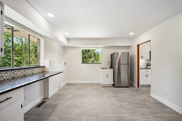 3017 Niles Buchanan Rd, Buchanan, MI 49107 - kitchen featuring freestanding refrigerator, decorative backsplash, white cabinetry, and recessed lighting