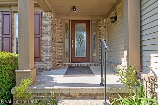 560 Boulder Lake Dr, Oxford, MI 48371 - doorway to property featuring brick siding and covered porch