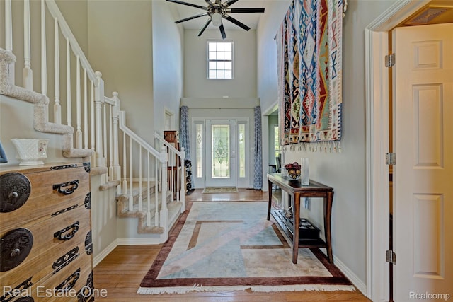 560 Boulder Lake Dr, Oxford, MI 48371 - entryway featuring stairs, ceiling fan, a high ceiling, and wood finished floors