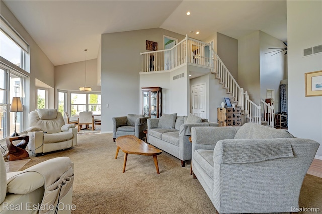560 Boulder Lake Dr, Oxford, MI 48371 - carpeted living area featuring high vaulted ceiling, stairway, and recessed lighting
