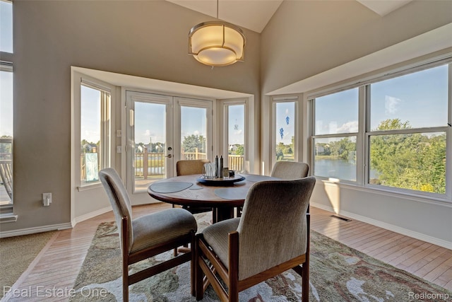 560 Boulder Lake Dr, Oxford, MI 48371 - dining area with french doors, high vaulted ceiling, and light wood-style floors