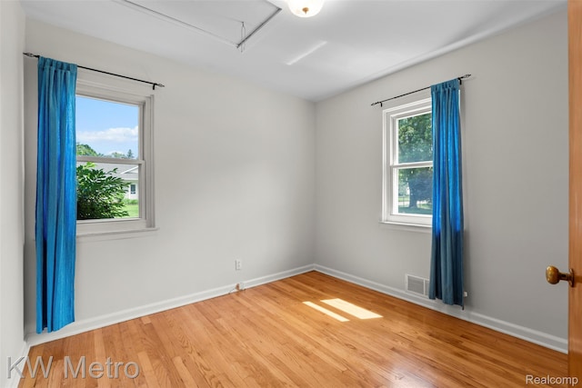 3180 Warringham Ave, Waterford, MI 48329 - empty room with wood finished floors and attic access