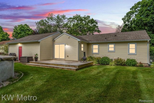 3180 Warringham Ave, Waterford, MI 48329 - back of house at dusk featuring a deck, a lawn, and a shingled roof