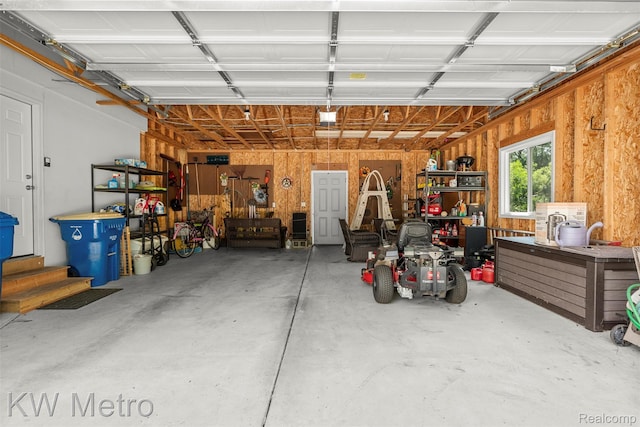 3180 Warringham Ave, Waterford, MI 48329 - garage featuring a workshop area and a garage door opener