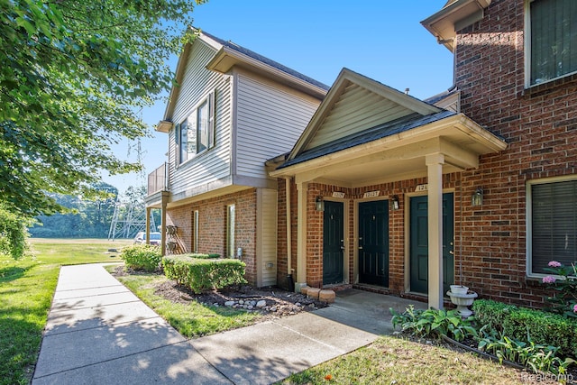 12129 Hidden View Ct, Utica, MI 48315 - entrance to property featuring brick siding and a yard