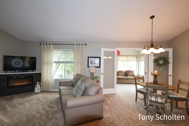 2956 Pebblestone Dr Unit 47, Hudsonville, MI 49426 - living room with carpet flooring, lofted ceiling, a chandelier, and a glass covered fireplace