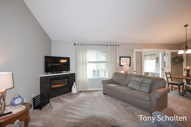 2956 Pebblestone Dr Unit 47, Hudsonville, MI 49426 - living room featuring plenty of natural light, carpet, a chandelier, and a glass covered fireplace