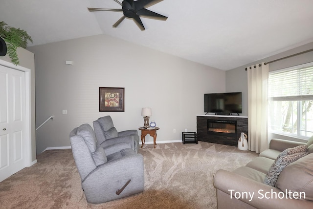 2956 Pebblestone Dr Unit 47, Hudsonville, MI 49426 - living area with carpet floors, lofted ceiling, ceiling fan, and a glass covered fireplace